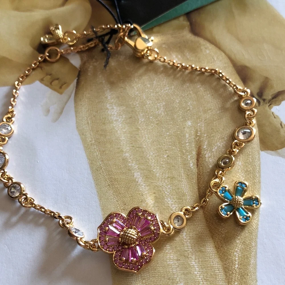 Authentic New with tag. kate spade Gold Bracelet with flower crystals.